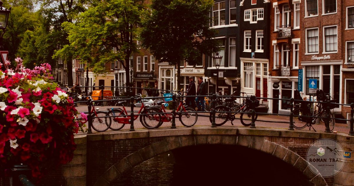 An Amsterdam canal bridge with bicycles and flowers, Netherlands