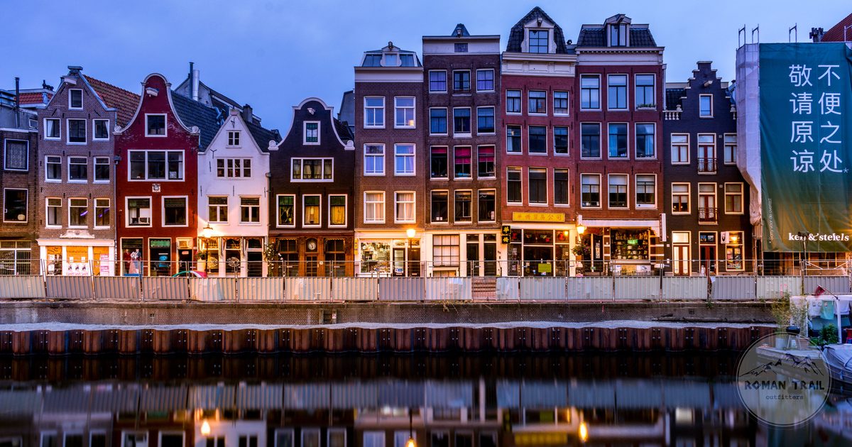 Canal houses reflected in the water in Amsterdam, Netherlands