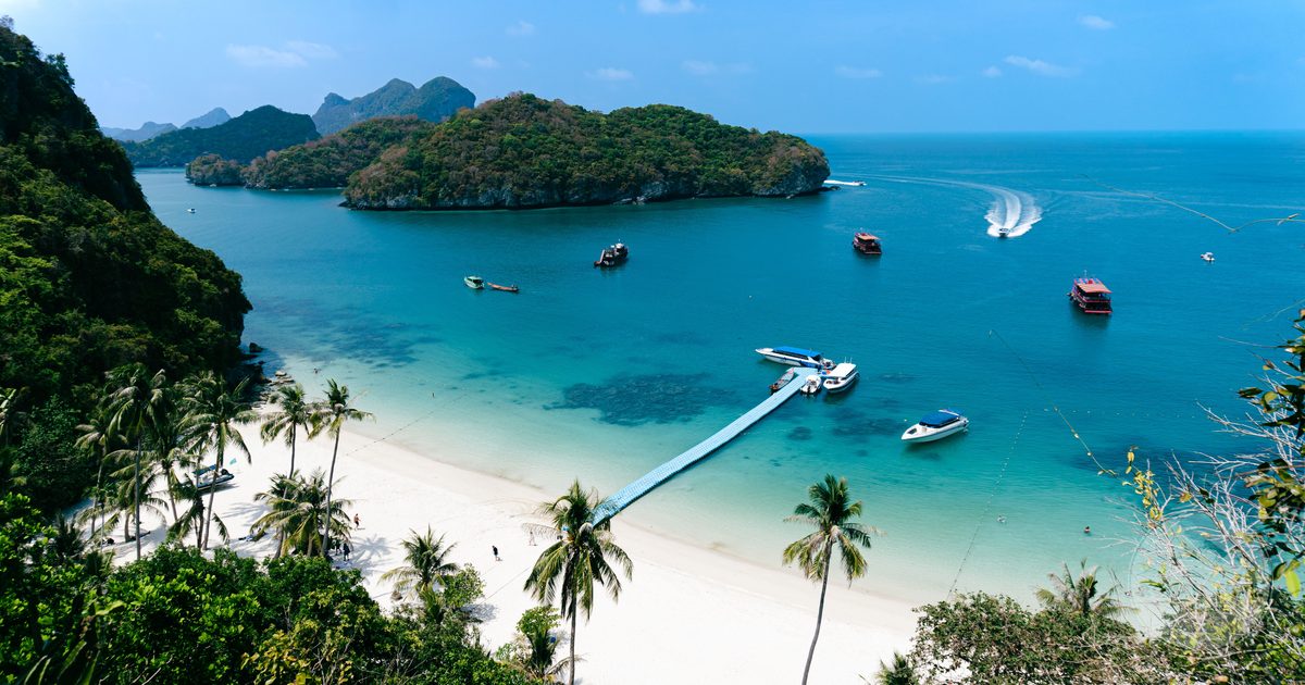 Aerial view of a tropical island beach with boats, Gulf of Thailand