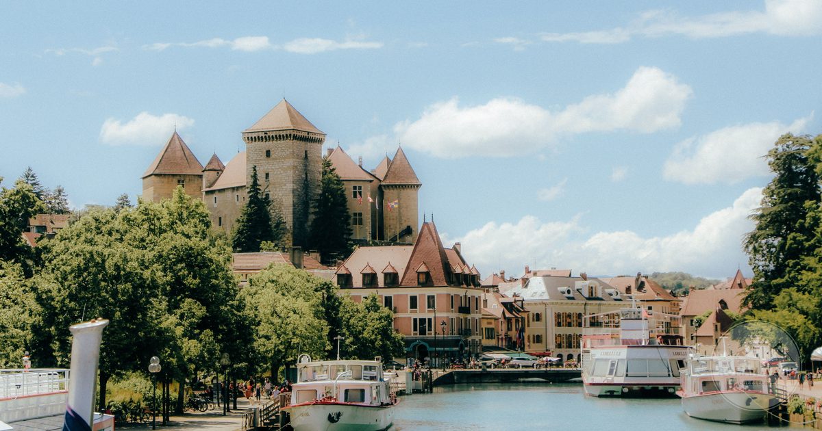 The Chateau d'Annecy above boats on the canal, France