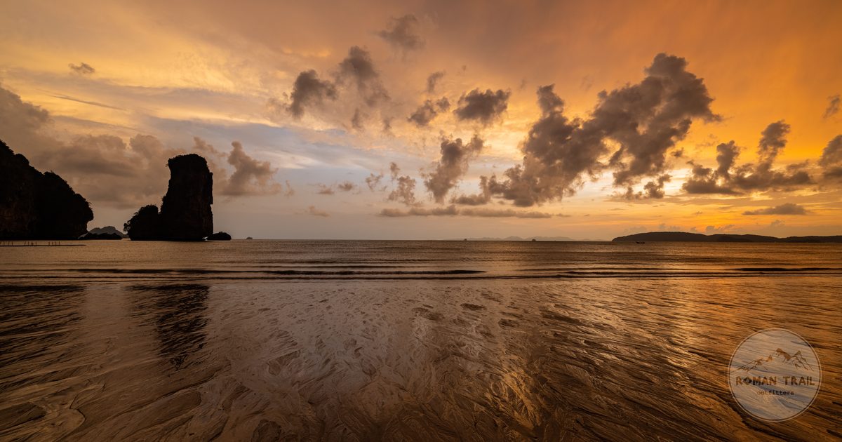 Sunset over Ao Nang Beach with rocky silhouettes, Krabi, Thailand