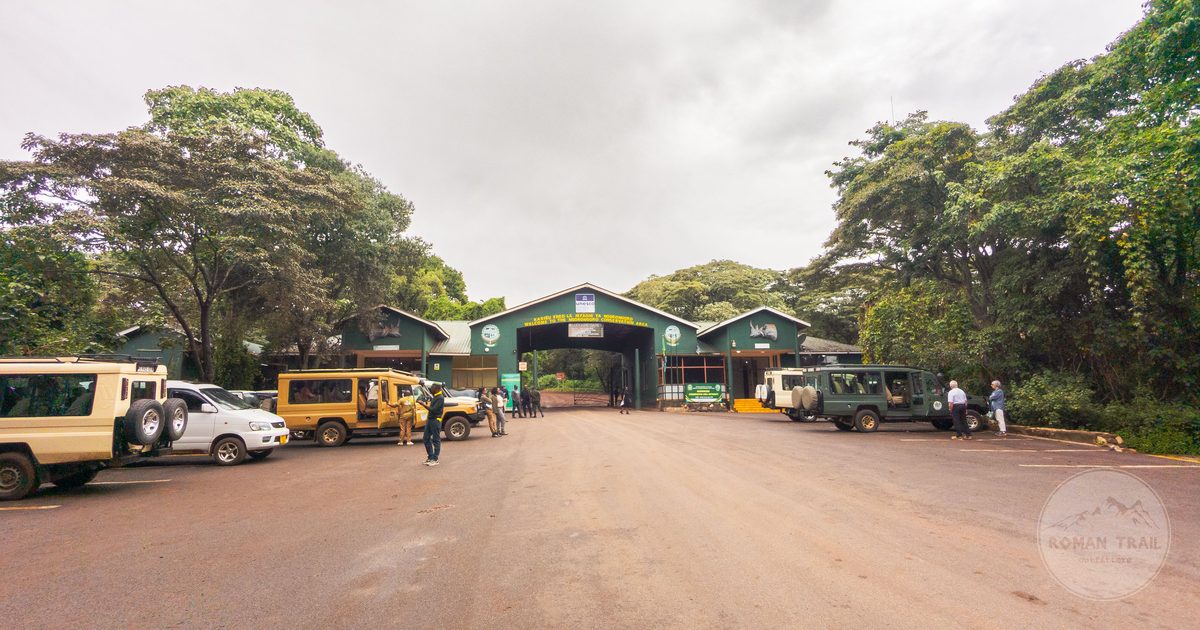 Safari vehicles at the entrance gate of Arusha National Park, Arusha packing list for women by Roman Trail Outfitters