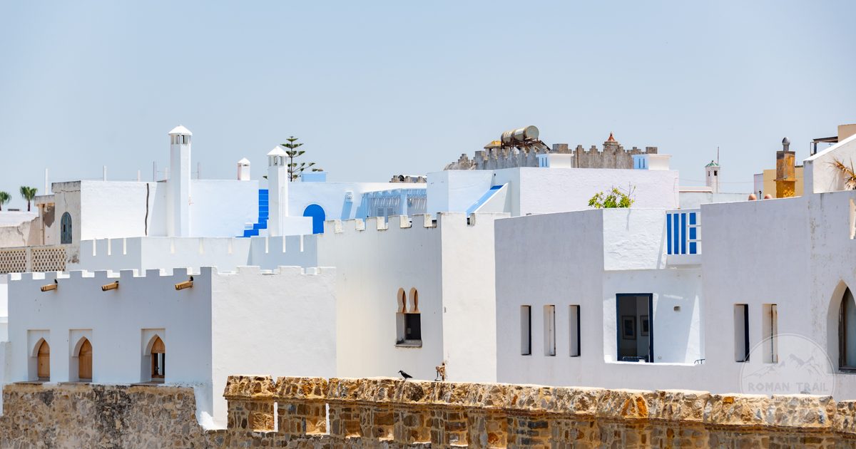Traditional white and blue buildings under clear sky at Asilah, Morocco
