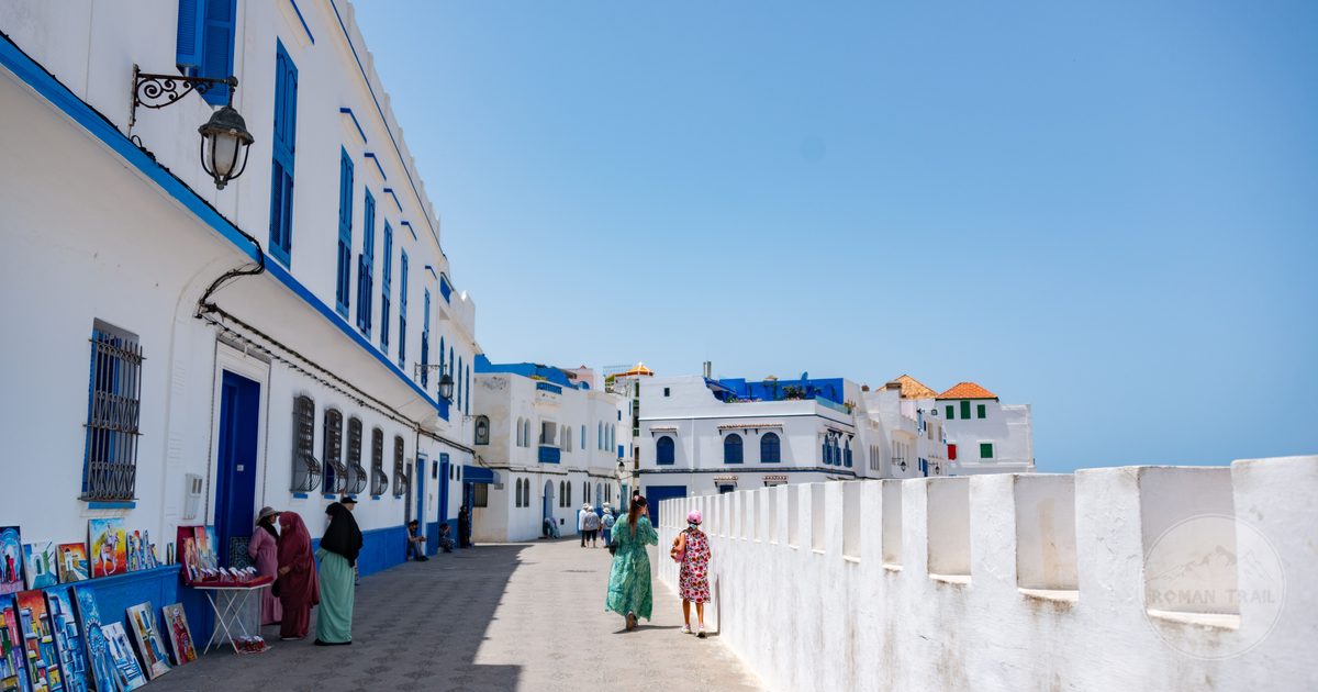Visitors in the white and blue streets of Asilah, Morocco