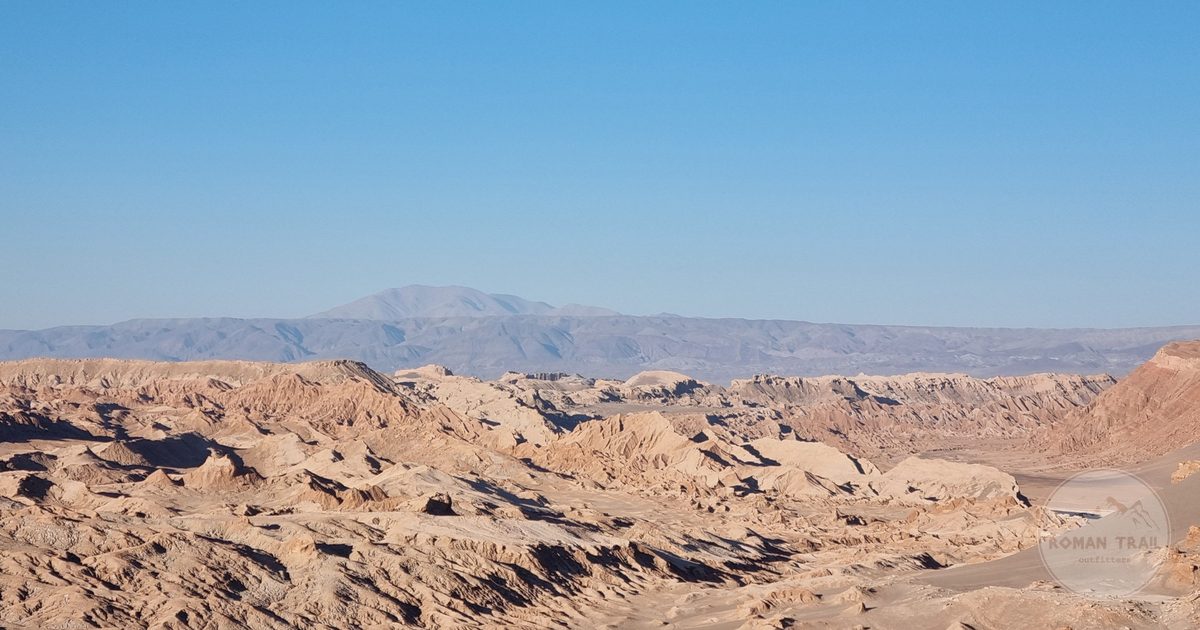 The arid landscape of the Atacama Desert under a clear sky at San Pedro de Atacama, Chile
