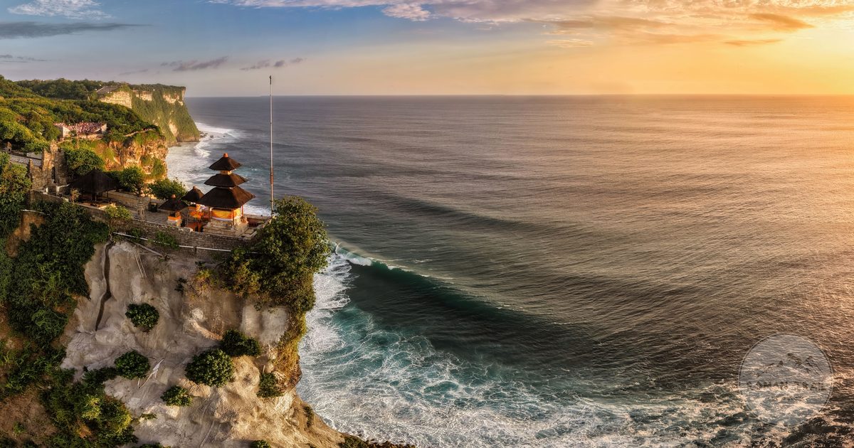 Uluwatu Temple on the cliffs above the ocean at sunset, Bali, Indonesia