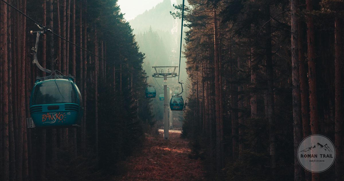 Cable cars crossing a misty pine forest at Bansko, Bulgaria