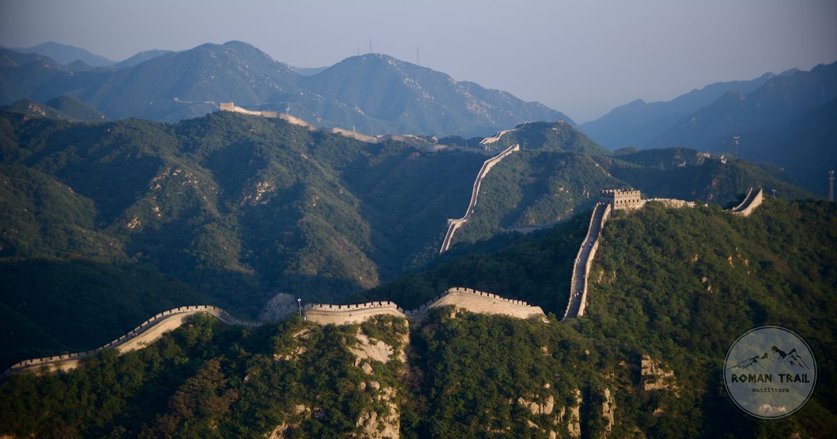 The Great Wall of China winding across forested mountain ridges near Beijing, Beijing packing list for women by Roman Trail Outfitters