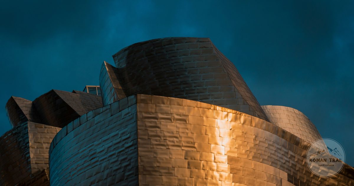 Close view of the curved titanium facade of the Guggenheim Bilbao, Bilbao packing list for women by Roman Trail Outfitters