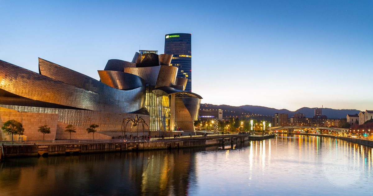 The Guggenheim Museum Bilbao reflected in the Nervion river, Bilbao packing list for women by Roman Trail Outfitters