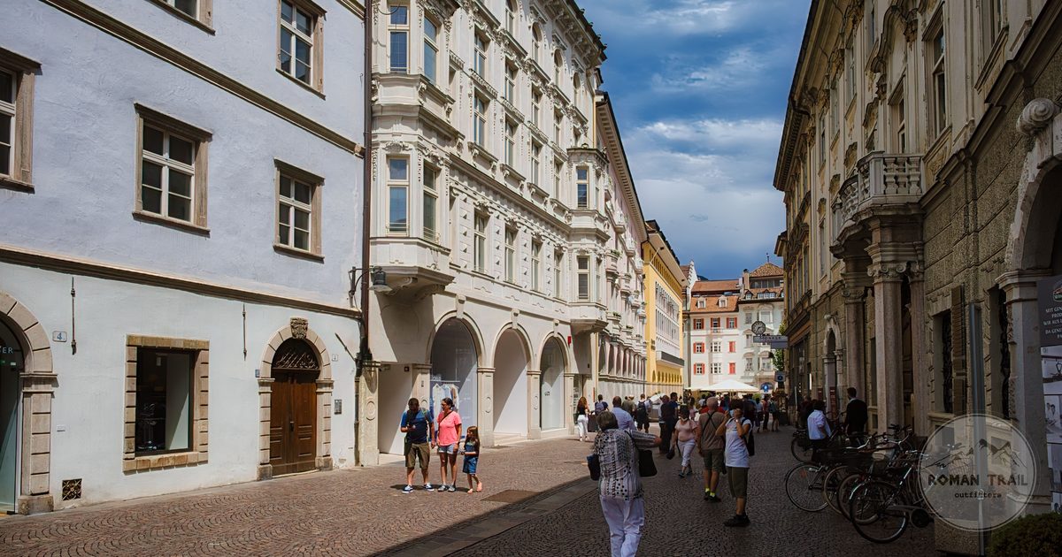 A cobblestone street with historic architecture in Bolzano, South Tyrol, Italy