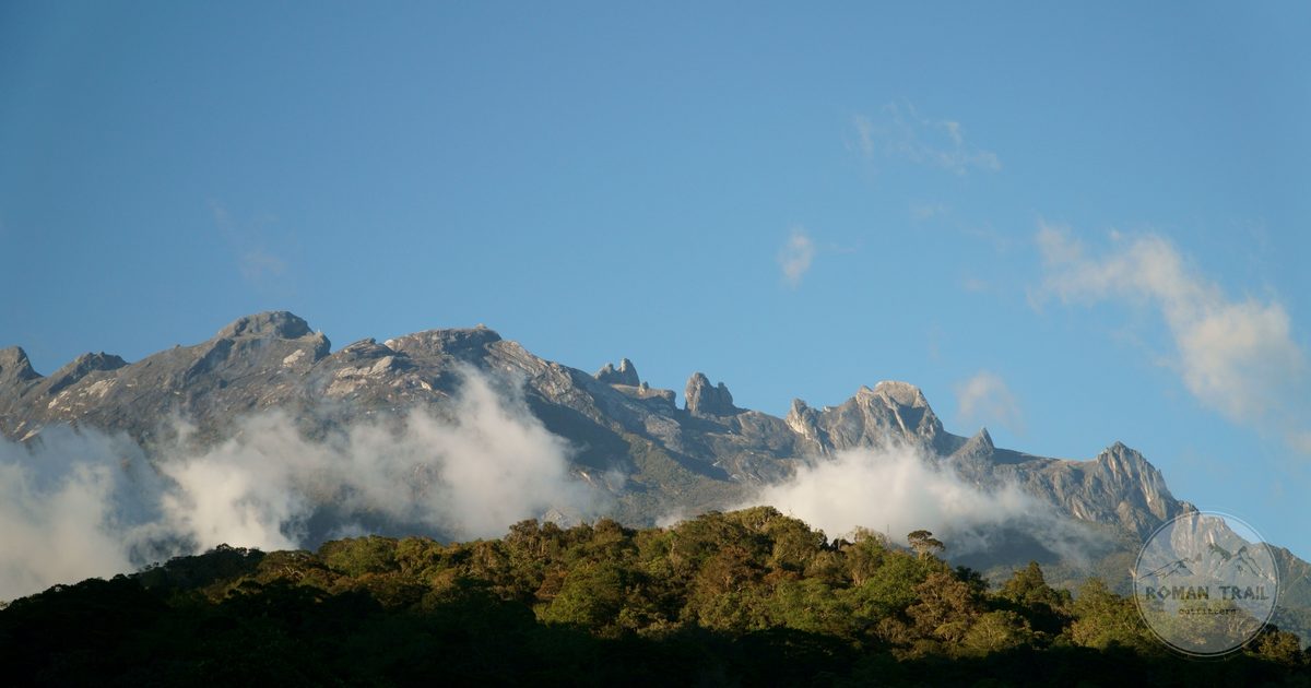 Mount Kinabalu rising above cloud at sunrise in Sabah, Borneo Malaysia packing list for women by Roman Trail Outfitters