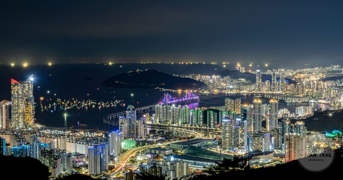 The Gwangan Bridge and the Busan skyline lit up at night, Busan packing list for women by Roman Trail Outfitters