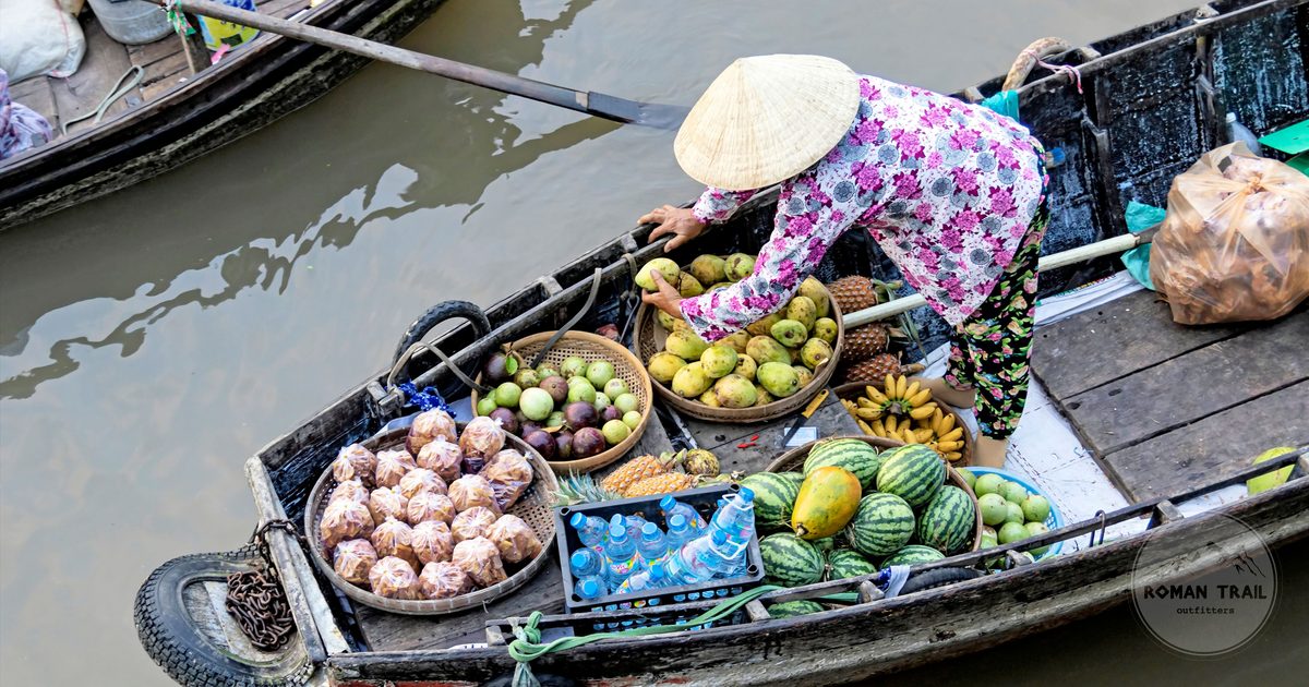 A fruit vendor on a boat at the floating market in Can Tho, Vietnam