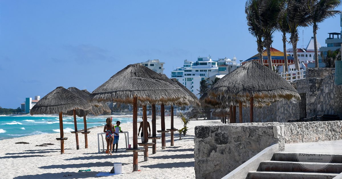 Palapas and sandy shore on a Cancun beach, Mexico