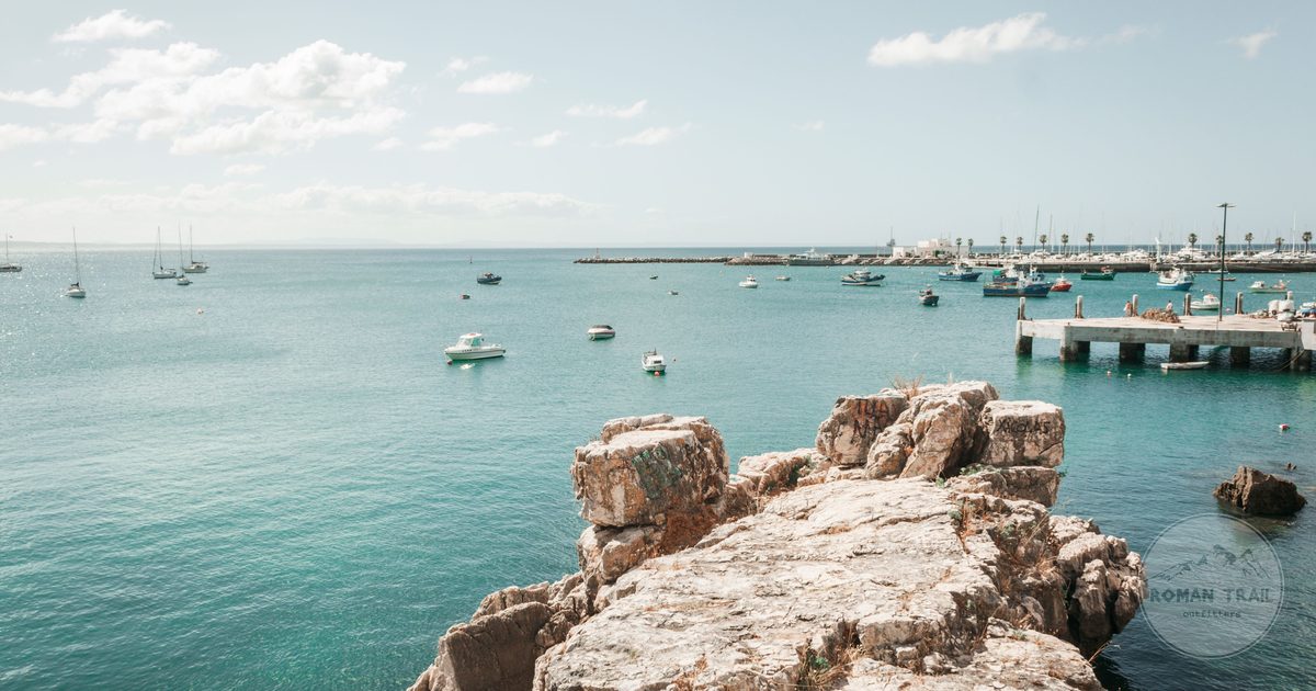 Boats and rocky shoreline on the coast at Cascais, Portugal