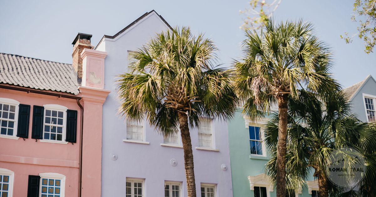 Pastel houses and palm trees on a sunny street in Charleston, South Carolina