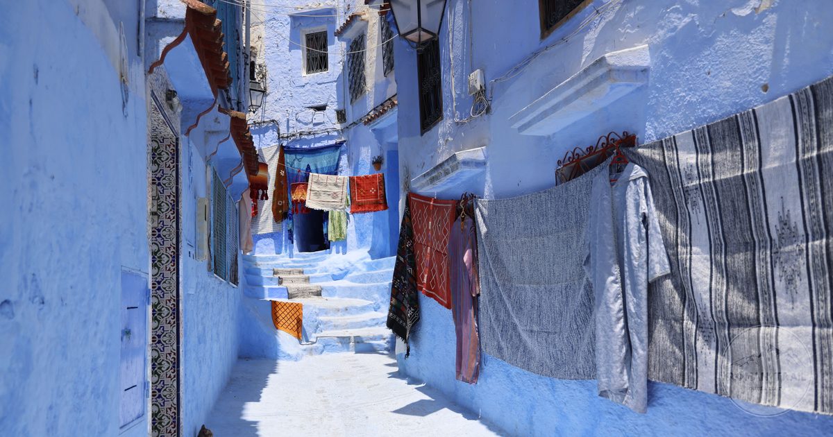 Blue alleyway with drying cloth in Chefchaouen, Morocco