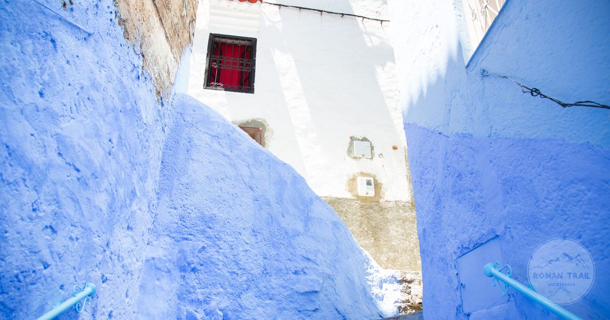 Blue painted steps between walls in Chefchaouen, Morocco