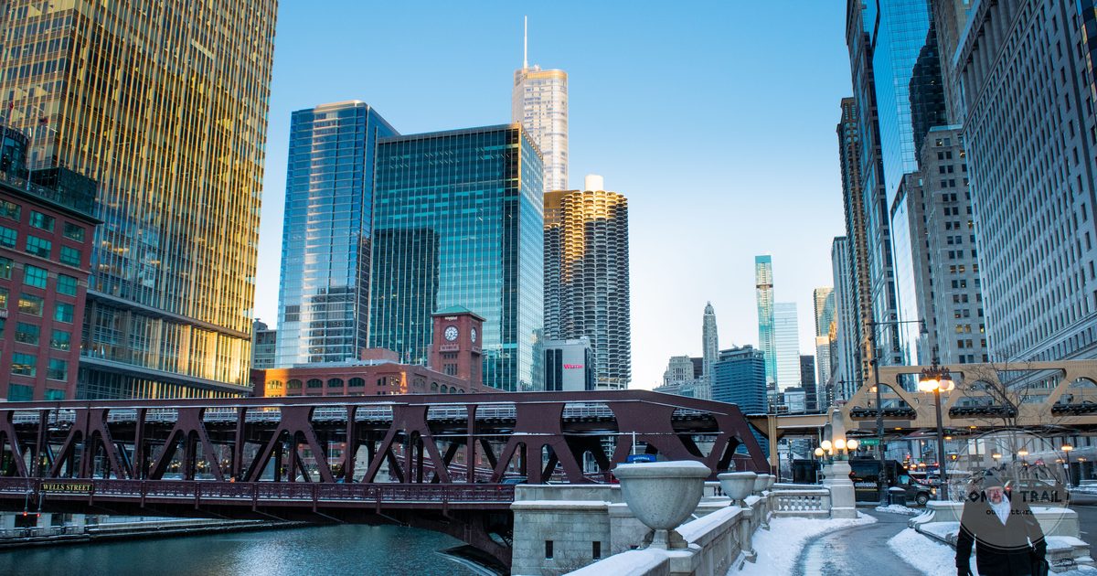 Snow along the Chicago River with downtown skyscrapers in winter light, Chicago for women travelers