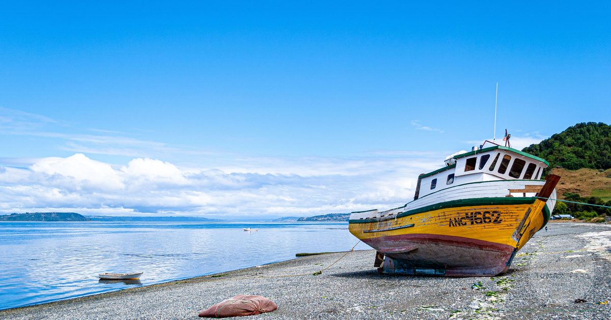 A fishing boat on the shore on Chiloé Island, Chile