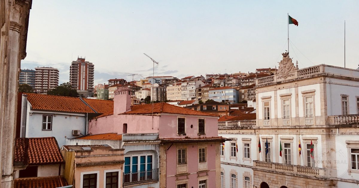 Narrow streets and old painted buildings in the Coimbra old town, Coimbra packing list for women by Roman Trail Outfitters