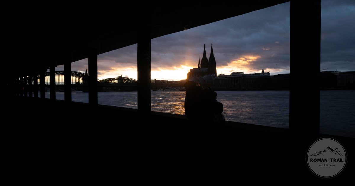 Cologne Cathedral and the Rhine seen through a colonnade at sunset, Germany