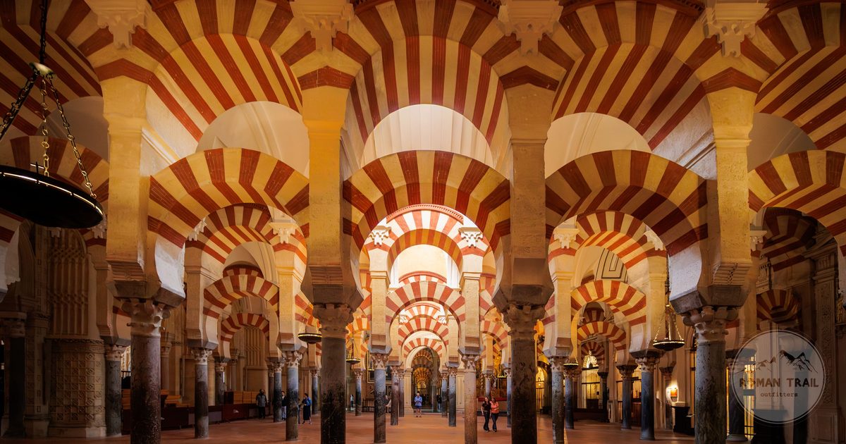 Rows of red and white arches in the Mezquita of Cordoba, Cordoba Spain packing list for women by Roman Trail Outfitters