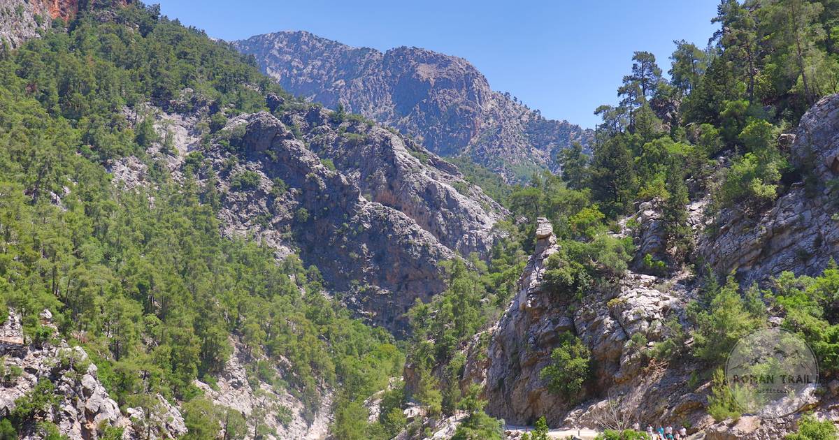 Hikers on a rocky trail in a mountain gorge, Crete, Greece