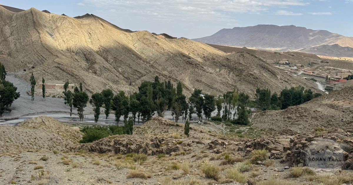 Trees and mountains along the Dades Valley under a partly cloudy sky, Morocco
