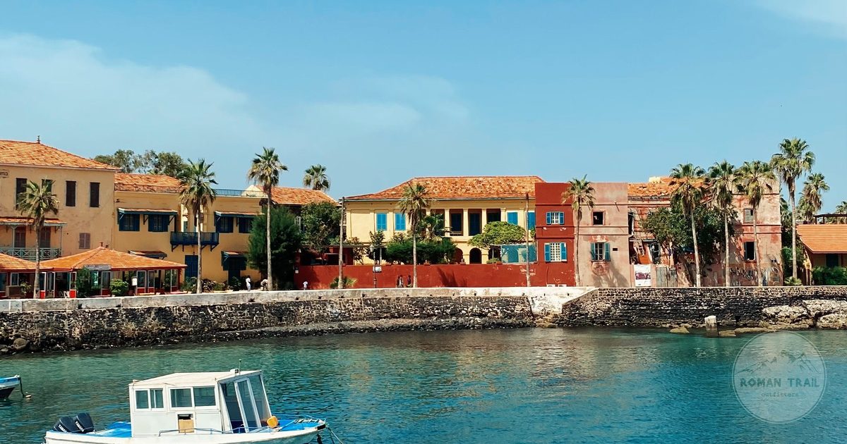 Colonial architecture on Gorée Island with a boat on the Atlantic, Senegal