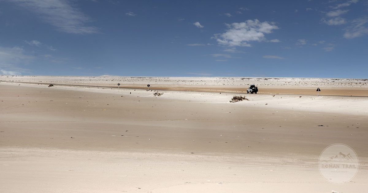 A vehicle in the vast desert landscape at Dakhla, Morocco