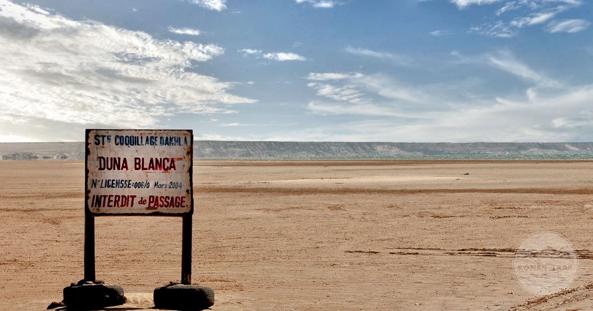 The Duna Blanca sign and dune in the desert at Dakhla, Morocco