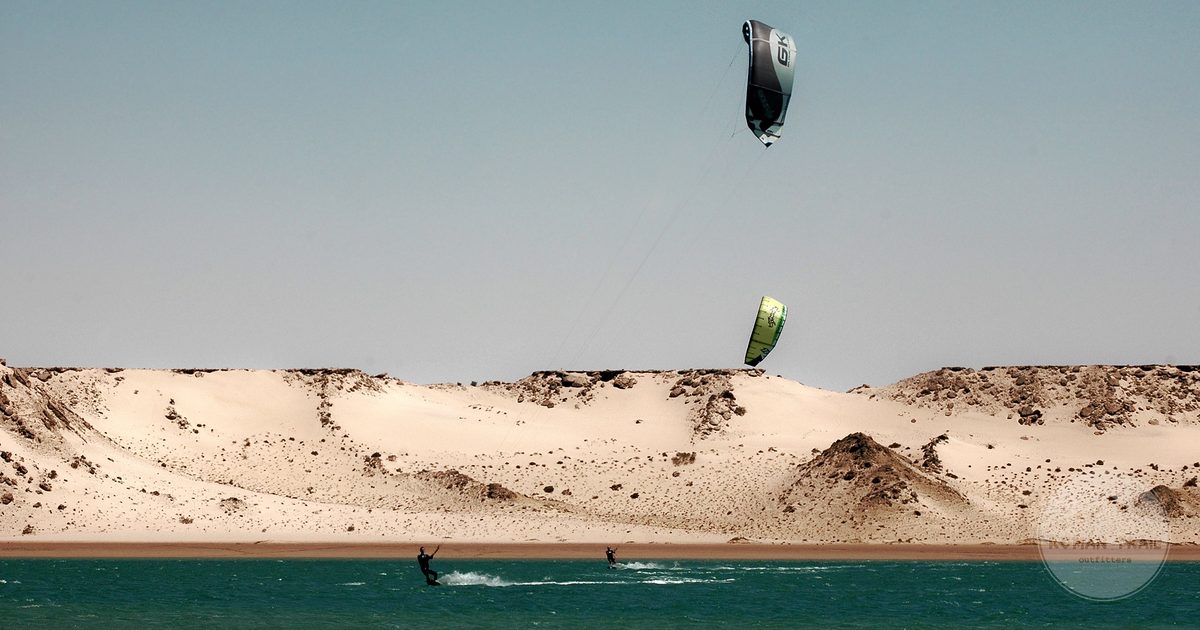 Kitesurfing on the lagoon against the desert backdrop at Dakhla, Morocco