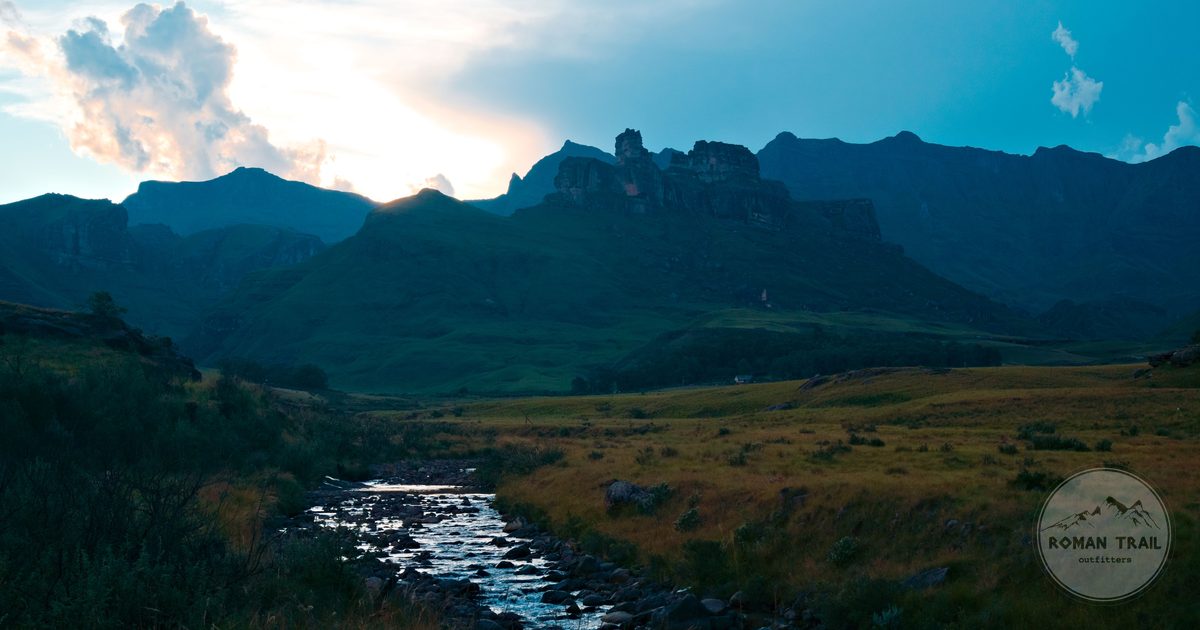 A mountain stream at dawn below dramatic sky, Drakensberg, South Africa