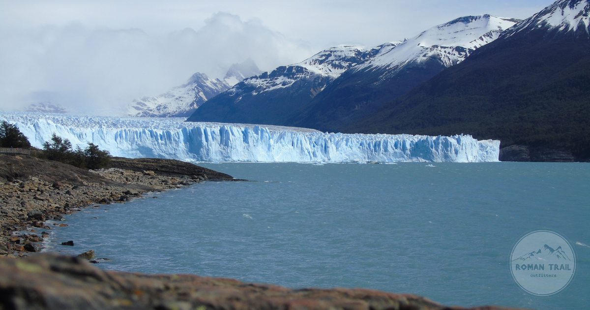Perito Moreno glacier below snow covered mountains near El Calafate, El Calafate packing list for women by Roman Trail Outfitters