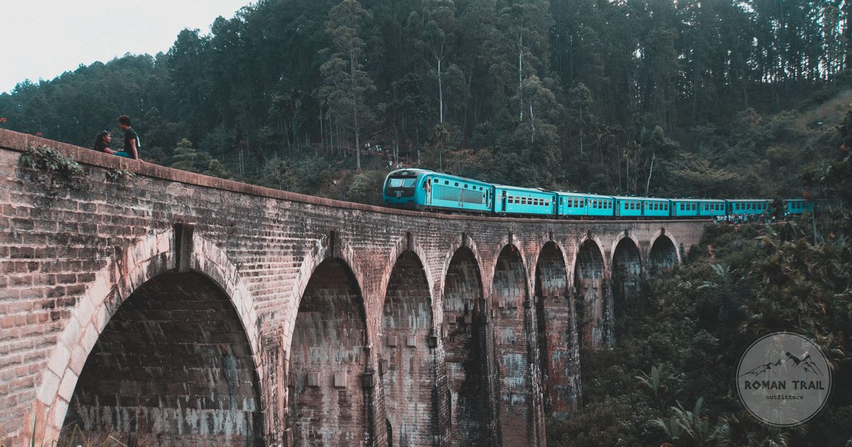 A blue train crossing the Nine Arch Bridge at Ella, Sri Lanka