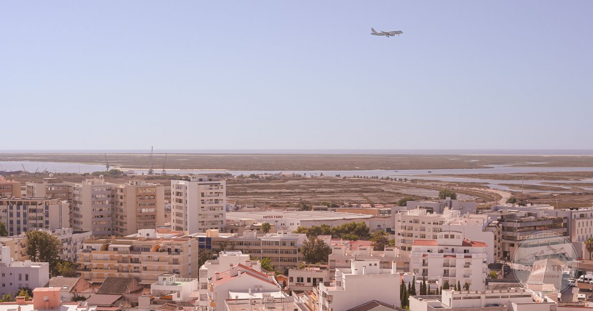 Aerial view of the city of Faro with an aircraft overhead, Portugal