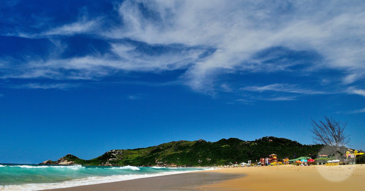 The golden sand and surf of Praia Mole in Florianopolis, Brazil