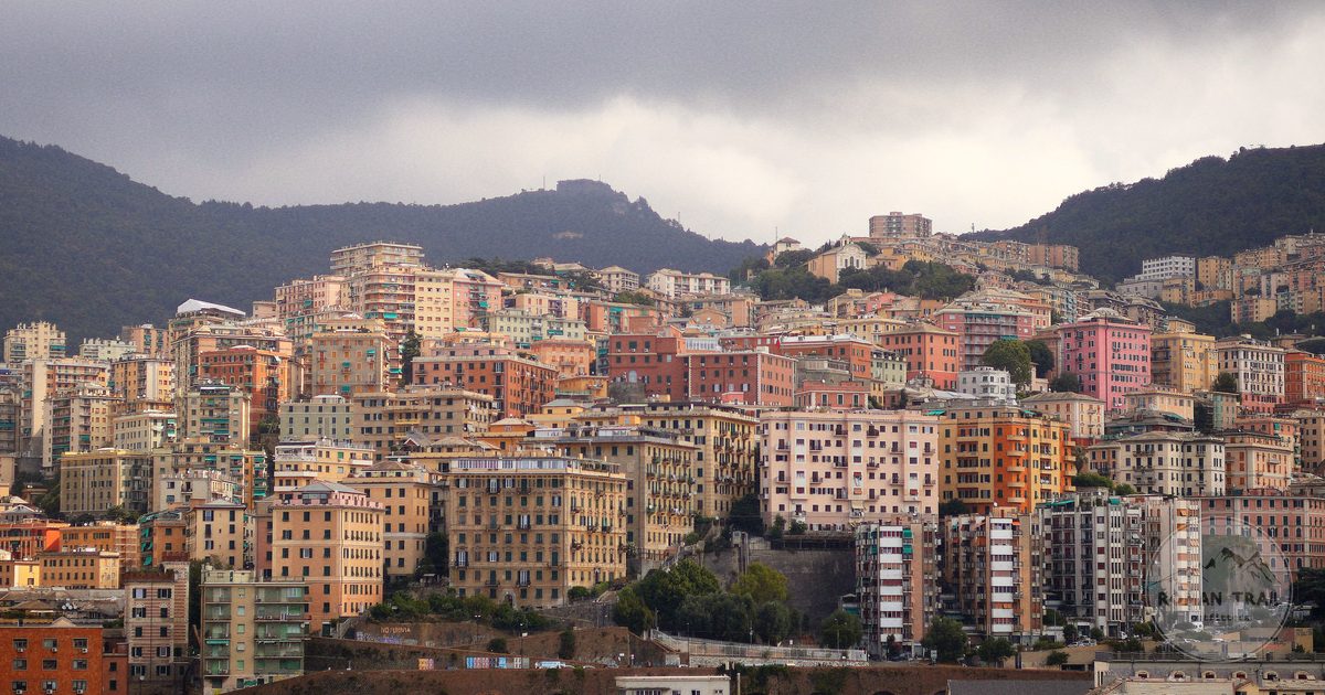 Colourful houses stacked on the hillside above Genoa, Genoa packing list for women by Roman Trail Outfitters