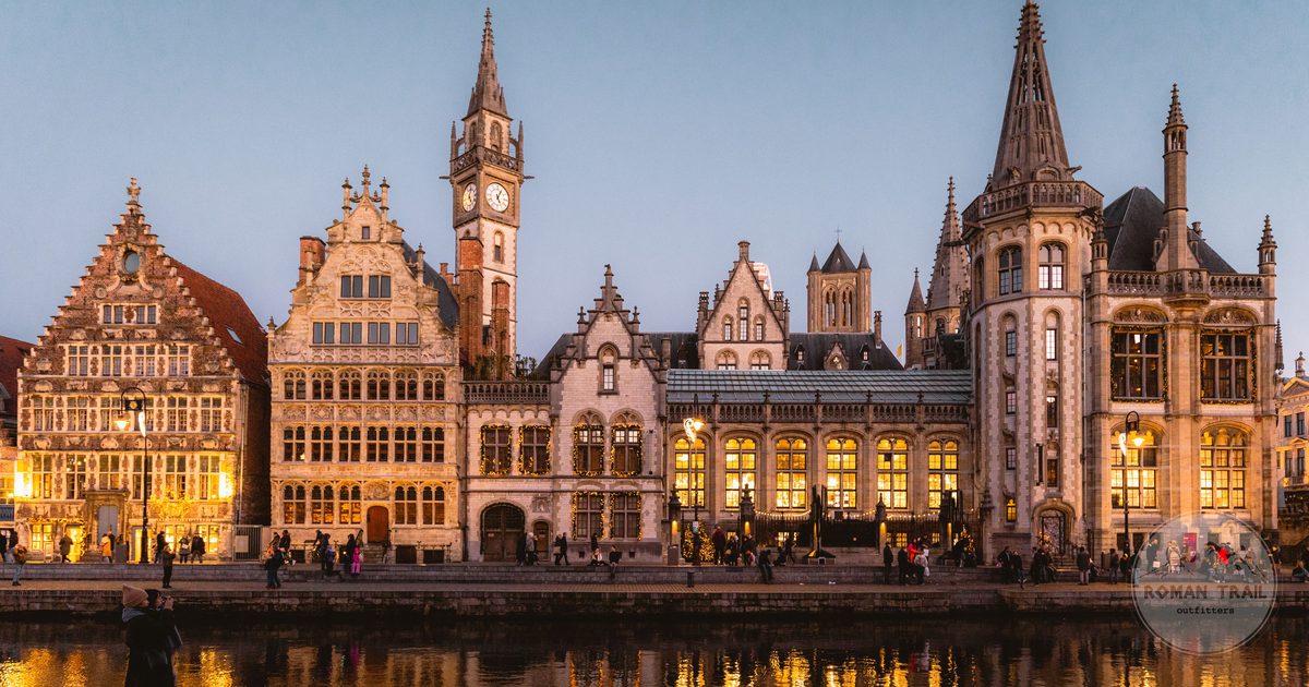 Medieval buildings lit at twilight along a canal in Ghent, Belgium