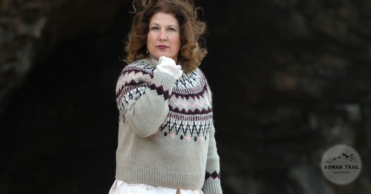 A woman outdoors in a warm patterned wool sweater