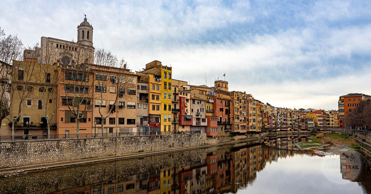 Riverside buildings reflected in the Onyar at Girona, Spain