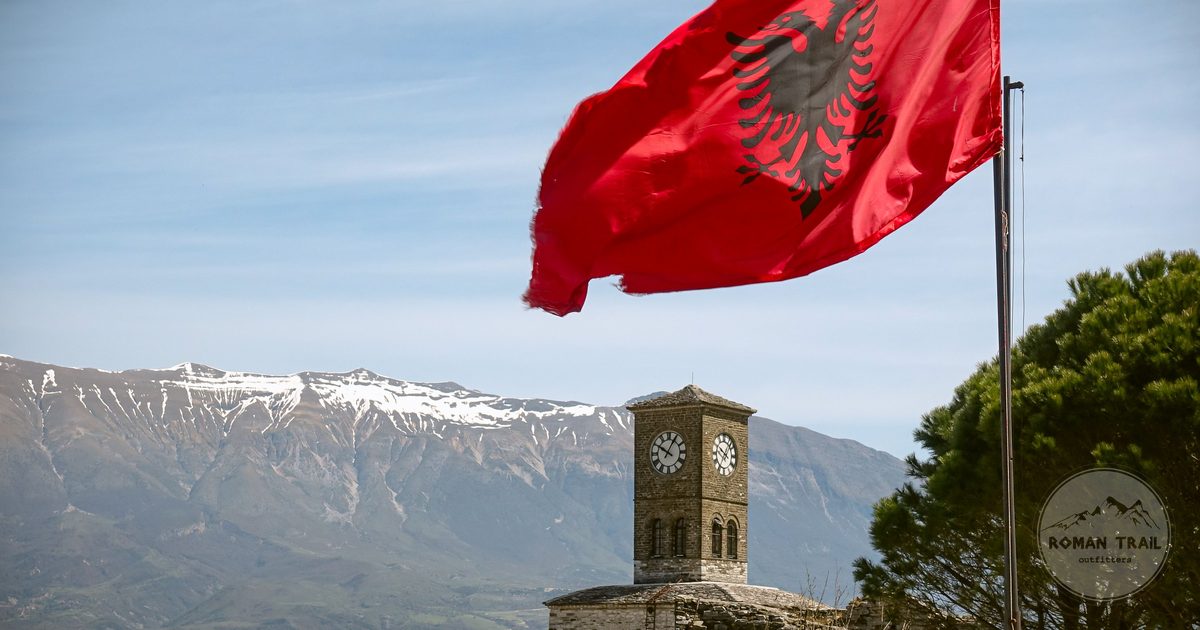 The Albanian flag and clock tower at Gjirokaster fortress