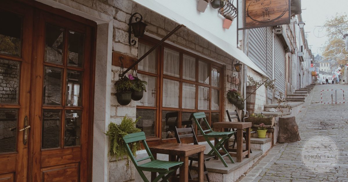 A street with outdoor café seating in Gjirokaster, Albania