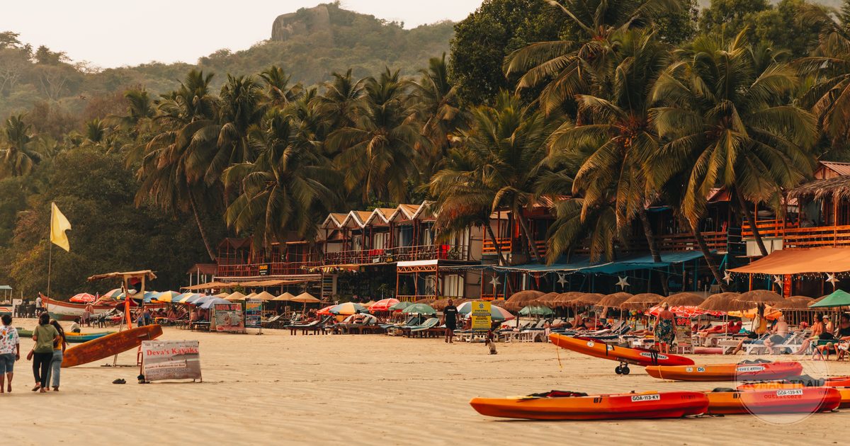 Palm trees, kayaks and beach huts at Palolem, Goa, India