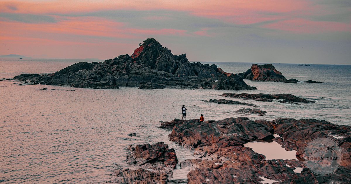 Rock formations and ocean at sunset at Kudle Beach, Gokarna, India