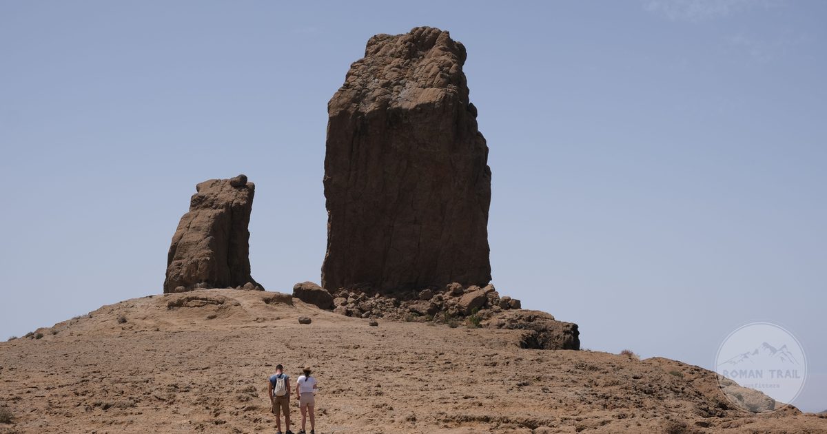 Walkers below the Roque Nublo rock formation in the Gran Canaria highlands, Gran Canaria packing list for women by Roman Trail Outfitters