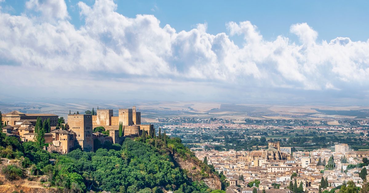 The historic Alhambra in Granada surrounded by greenery, Spain