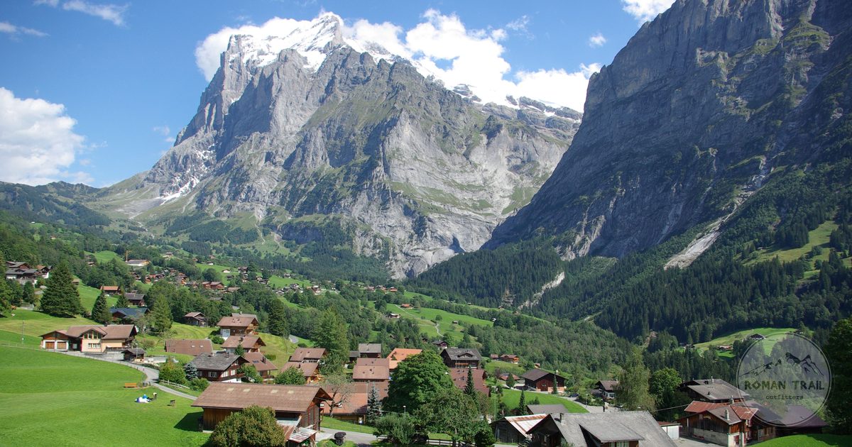 A Swiss alpine village below snow covered peaks, Grindelwald packing list for women by Roman Trail Outfitters